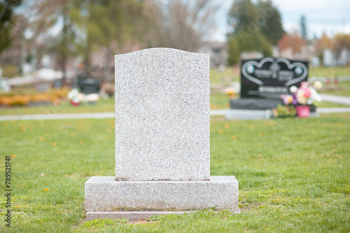 A large blank tombstone in a cemetery. 