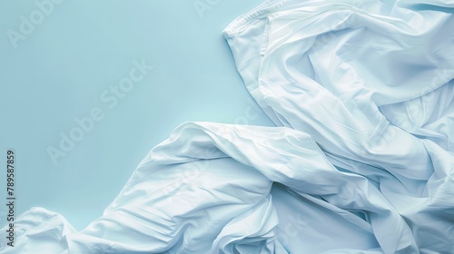 White cloth on a blue background. The fabric is wrinkled and has a soft texture.