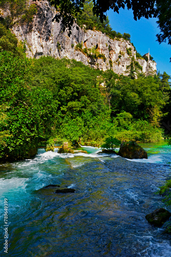 spieniona woda w górskim strumieniu, turkusowa woda w górskim potoku w Prowansji, zielone krzewy otaczajace górski strumień z lazurową wodą, turquoise water in a mountain stream, Provence, France