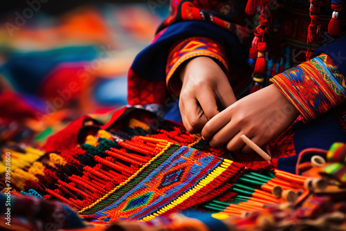 hands of south american woman weaving very colorful fabrics by hand