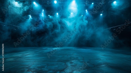 An empty theater stage with blue lights and smoke