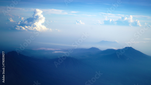 Aerial view of Bali island from the airplane. The earth panorama with Bali island view , mountain, blue sky and white cloud background. Natural nature landscape background.