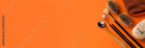 Reflexology tools web banner. Various implements used in reflexology therapy isolated on orange background with copy space.