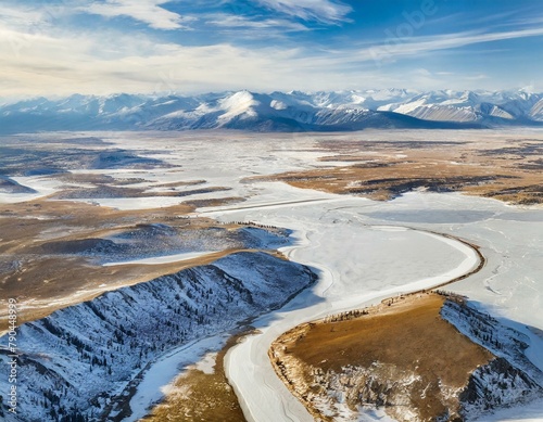 Top view, A frozen tundra landscape, its icy plains spreading out like a white sheet beneath the viewer, punctuated by frozen lakes and snow-capped mountains.