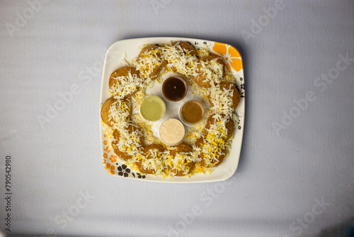 special Fuchka, dahi puri, pani puri, or gol gappa with sauce and chutney served in dish isolated on grey background top view of bangladeshi street food