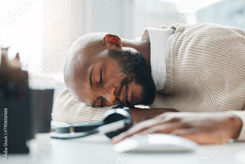 Sleeping, burnout and tired agent in call center overwhelmed by deadlines with fatigue in customer service. Lazy worker, depressed consultant or exhausted black man resting or taking nap in overtime