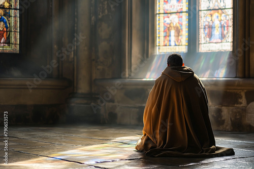 christian catholic monk or friar praying in the abbey at the window