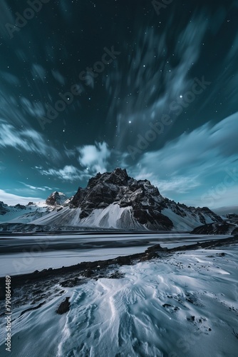 Icelandic mountains with aurora in the sky and snow on the ground,
