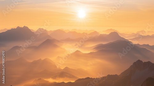 Golden rays of dawn cascading over tranquil mountain ridges in a majestic sunrise panorama
