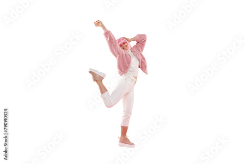 Full length portrait of young happy girl wearing funky clothes and colored wig, dancing and jumping at party