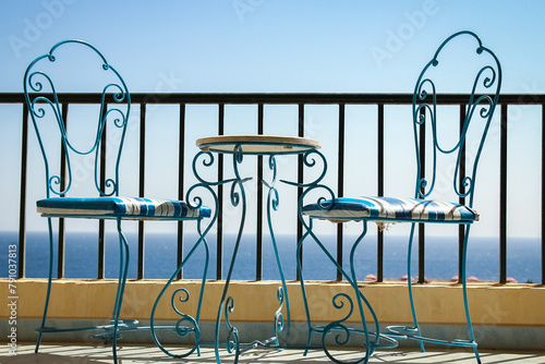 Beautifully stylish table chairs on the sea shore background