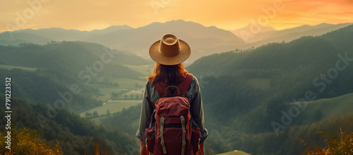 woman traveler with backpack holding hat