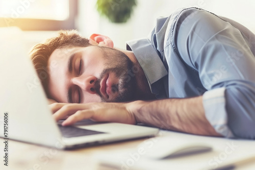 Office burnout: tired man dozes off with computer