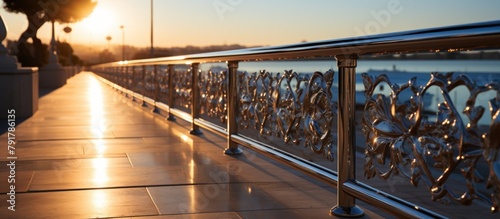 Metal railing on the embankment of the river at sunset.