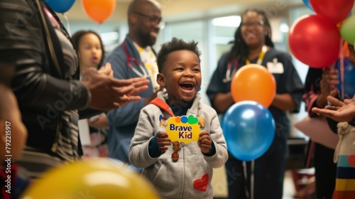 An African American child beams with joy, looking at a colorful "Brave Kid" sticker just received after vaccination.
