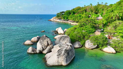 Majestic rocky cliffs embrace lush greenery overlooking the mesmerizing azure sea, a haven of tranquility and natural wonder. Flight over the sea. Ko Tao, Surat Thani Province, Southern Thailand. 