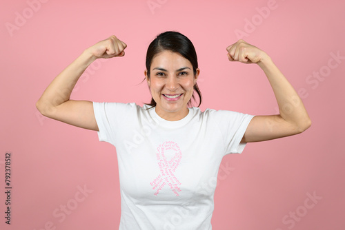Happy woman with ribbon on pink background. Breast cancer awareness concept