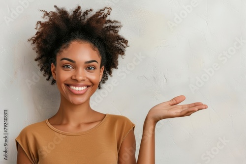 Smiling woman gesturing with confidence presenting space with palm up isolated on white background Positive human emotion signs facial expression