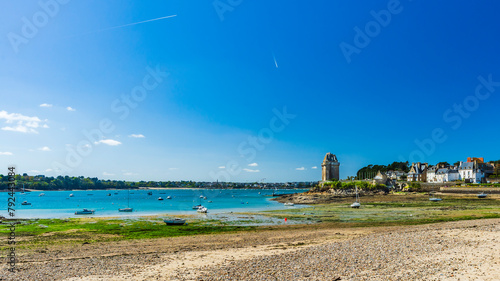 Panoramic view of the Solidor Tower in Saint-Malo in Brittany, under a blue sky and at low tide.