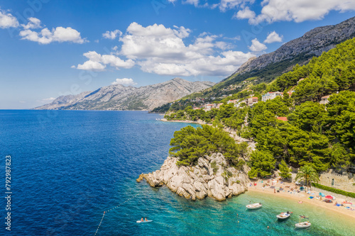 Aerial view of Punta Rata beach with boats and azure sea in Brela, Croatia, Dalmatia, Croatian azure coast