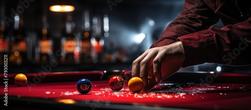 Young man playing billiards at night club. Close up of billiard player hands playing in pool.