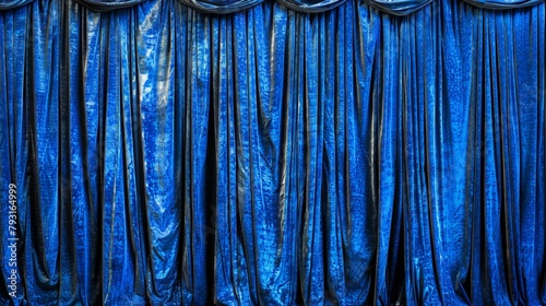  A detailed view of a blue curtain with a metal pole centrally positioned through it