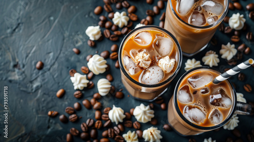 Tall glasses of iced coffee with ice cubes on a dark background, accompanied by coffee beans. Copy space.