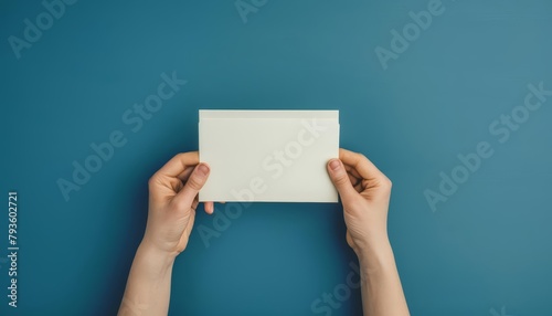 Person holding envelope above voting ballot against blue backdrop, symbolizing core values of democracy