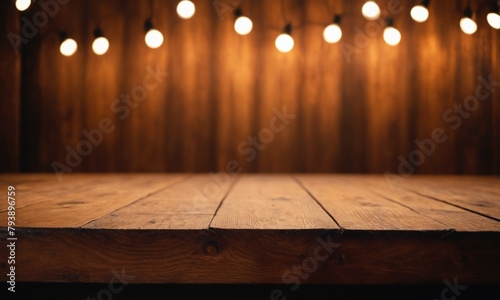 Empty rustic wooden table top for product placement or montage. Blurred light on the wall in cafe or bar background for product presentation backdrop, display, mock-up with space for text.