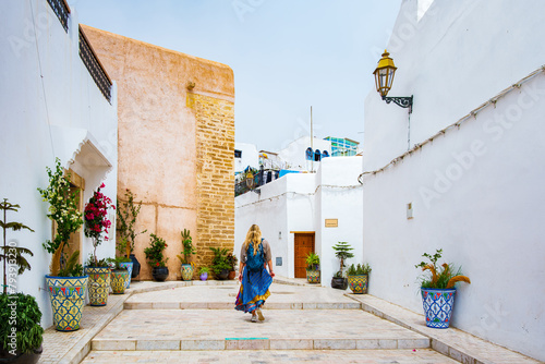 Occidental blonde girl in Kasbah of Udayas fortress in Rabat Morocco. Kasbah Udayas is ancient attraction of Rabat Morocco, near Bou Regreg river.