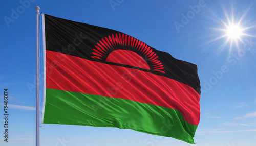 Die Fahne von Malawi, flattert im Wind, isoliert, gegen den blauen Himmel