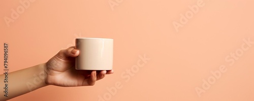 Stylish hand model presenting a cup of coffee, with a minimalist background to keep the focus on the hand and cup
