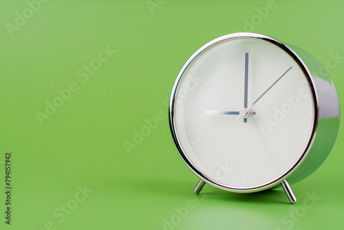 Time, standing still, time hand, photo of a moving clock on a green background, time concept.