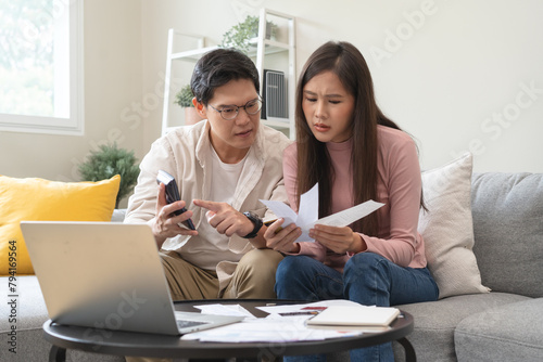 Stressed financial owe asian young couple love sitting suffer, stressed and confused by calculate expense from invoice or bill, no money to pay, mortgage or loan. Debt, bankrupt or bankruptcy people