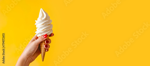 Close up shot of female hand holding milk ice cream cone.Hello summer and relaxation concepts.sweet taste dessert and healthy eating ideas