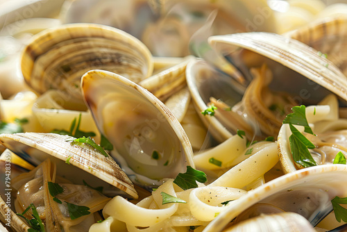 A savory dish of steamed clams and linguini garnished with parsley, served steaming hot in a casserole