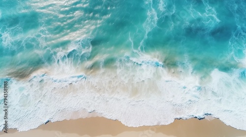 Ocean waves on the beach as a background. Beautiful natural summer vacation holidays background. Aerial top down view of beach and sea with blue water waves.