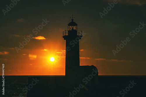 Felgueiras Lighthouse in silhouette with beautiful colorful sunset sky. Porto, Portugal. 