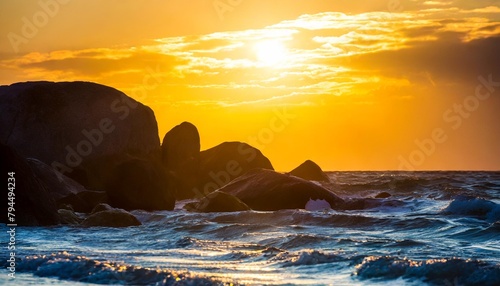 dramatic scene with big rocks sea sunbeam and sundown