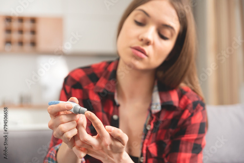 Woman using a glucose monitor. Diabetic disease