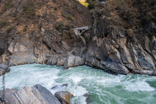 An old bridge opposite the landscape of Tiger Leaping Gorge in Yunnan province of China.