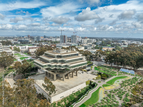 Aerial view of Geysel library at the University of California San Diego, futuristic building, columns holding up upper floor like books, next to the snake path