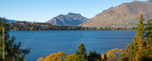 Panoramic scenery of beautiful landscape at the waterfront of Lake Wakatipu, with Kelvin Peninsula and majestic mountains in the distance. Panorama scenic view of Queenstown, New Zealand.