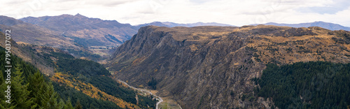 Panoramic scenery of New Zealand's natural landscape with mountains and Queenstown Hill, and Gorge Road winding between the valleys in the distance.