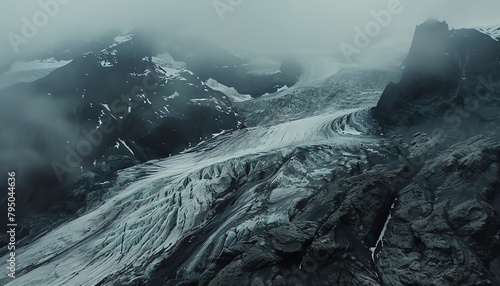 A grayscale aerial image of a glacier in the mountains.