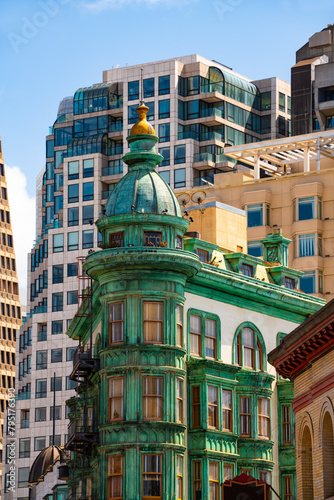 Historic and modern buildings on Columbus Avenue in downtown San Francisco California, Financial District and Chinatown. Colorful Columbus Tower from 1907 with copper-green Flatiron style structure.