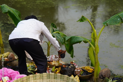 photograph of a man worship chhath puja images 