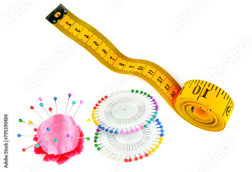 Measuring tape, sewing pinsand pincushion isolated on white. There is free space for text. Collage.