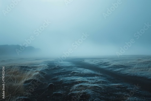 b'Foggy Icelandic Landscape with a Rocky Mountain in the Distance'