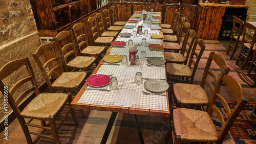 big table in restaurant with plates spoons and forks in warm wooden room